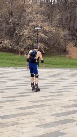 Man rollerblades in Cheboksary park wearing protective gear