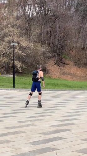 Man rollerblades in Cheboksary park wearing protective gear