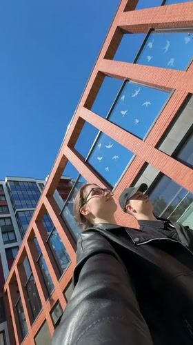 Modern red brick apartment complex explored across Saint Petersburg streets