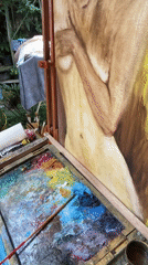 Paintings, incense, and a guitar in a Balinese studio