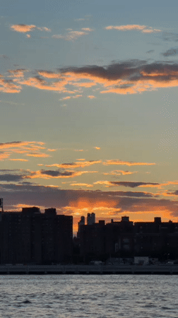 Sunset captured over New York waterway and skyline