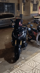 Motorcycles parked on wet street in Meknes after rain