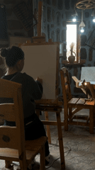 Artist sketches on canvas in stone-walled studio in Armenia