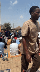 Men gather for prayers in Abuja courtyard