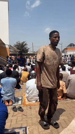 Men gather for prayers in Abuja courtyard
