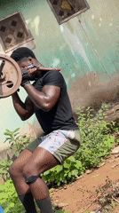 Man performs barbell squat workout in Akwanga, Nigeria
