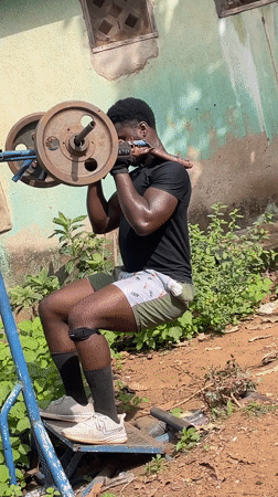 Man performs barbell squat workout in Akwanga, Nigeria