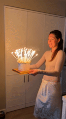 Woman celebrates birthday with meringue cake in Barcelona home