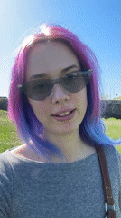 Pink-haired woman films video message in sunny Zagreb park
