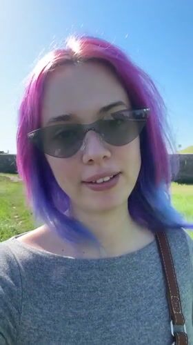 Pink-haired woman films video message in sunny Zagreb park