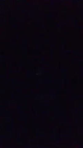 The video shows a dark scene with a small illuminated digital display in the center. The display shows the number "8," then briefly flickers before changing to "0." A faint light or reflection is visible below the display. The scene appears to be indoors, given the lack of environmental sound or other visual cues. The video is short and provides no further context or information.
