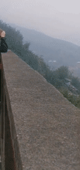 Tourists view misty Sa Pa terraced valleys from overlook