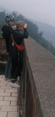 Tourists view misty Sa Pa terraced valleys from overlook