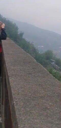 Tourists view misty Sa Pa terraced valleys from overlook