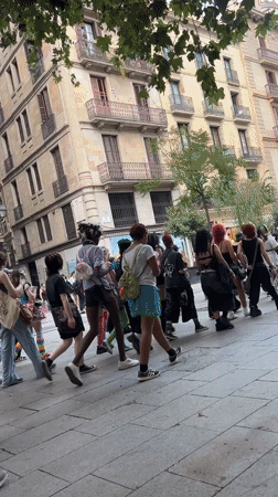 Casual street traffic through a Barcelona commercial district