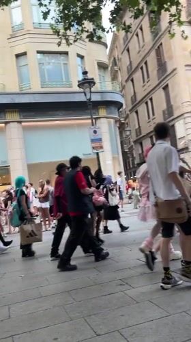 Casual street traffic through a Barcelona commercial district