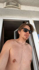 Man poses shirtless on Montenegro balcony overlooking Adriatic Sea