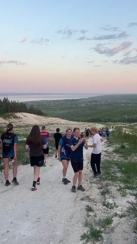 Group walks hillside paths in Khvalynsk during afternoon outing