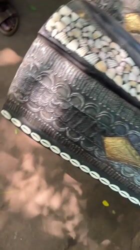 Visitor documents traditional crafts at Accra cultural center