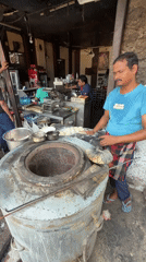 Baker prepares fresh dough at tandoor oven in Delhi