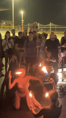 Fire performers draw a crowd on the Tel Aviv beachfront at night