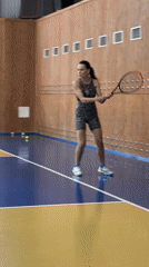 Woman plays early morning tennis in Russian gymnasium