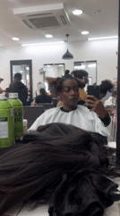 Woman takes selfie during hair salon visit in Paris