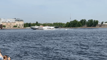Morning river traffic observed along Saint Petersburg's Neva embankment