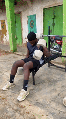 Young man exercises with makeshift concrete weights in Nigeria