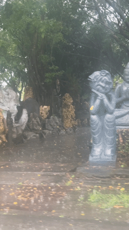 Rainy day documentation of shrine and vehicle in North Kuta