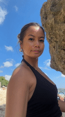 Woman films beach selfie in Kuta Selatan, Indonesia