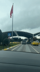 Vehicle approaches Sabiha Gokcen Airport on wet highway