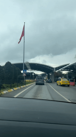 Vehicle approaches Sabiha Gokcen Airport on wet highway