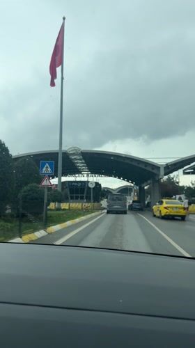Vehicle approaches Sabiha Gokcen Airport on wet highway