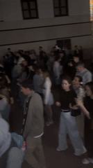 Large crowds gather across urban locations during evening hours