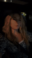 Woman gestures while speaking in car at night in Montenegro