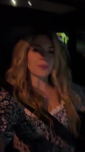 Woman gestures while speaking in car at night in Montenegro
