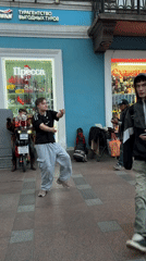 Breakdancer performs on Saint Petersburg street with musician accompaniment