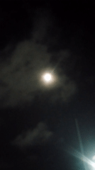 Full moon rises over a cloudy night in Caracas