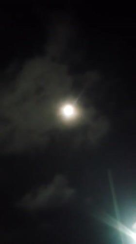 Full moon rises over a cloudy night in Caracas