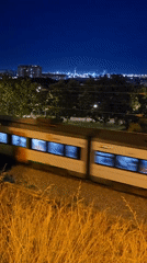 Train passes industrial art installation in Cornellà de Llobregat