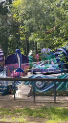 Amusement park rides in motion, from kiddie to thrill