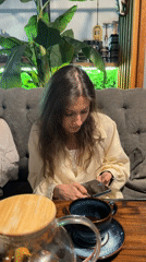 Woman uses phone at café table
