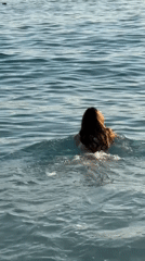 Swimmer enters turquoise waters at Fethiye beach, Turkey