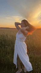White dress, tall grass, golden hour in rural Russia