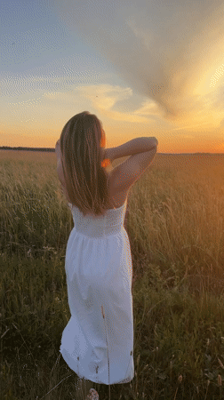 White dress, tall grass, golden hour in rural Russia