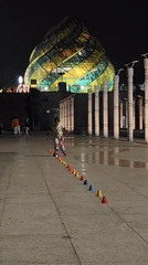 Child practices nighttime roller skating in Da Lat plaza