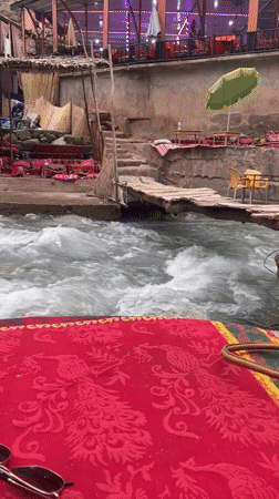 Riverside dining and cherry vendors active in Asgaour, Morocco