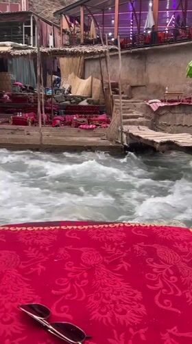 Riverside dining and cherry vendors active in Asgaour, Morocco
