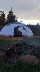 Dome tent and campfire on sandy ground in Mũi Né